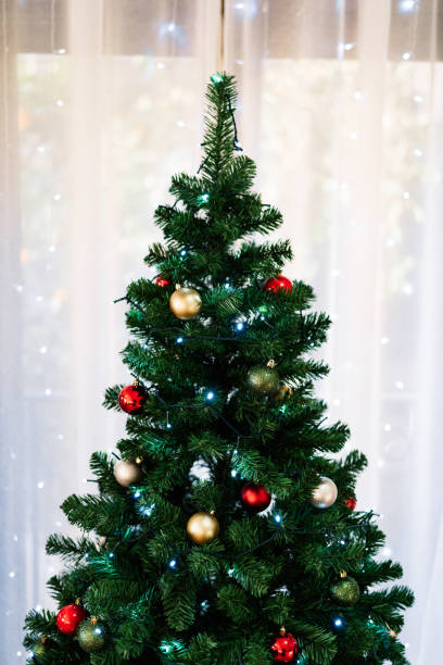istock Green fluffy Christmas tree with Christmas balls. 1279503359
