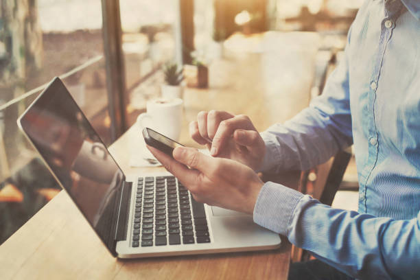 istock hands holding smartphone in cafe, banking online, freelancer 1279503437