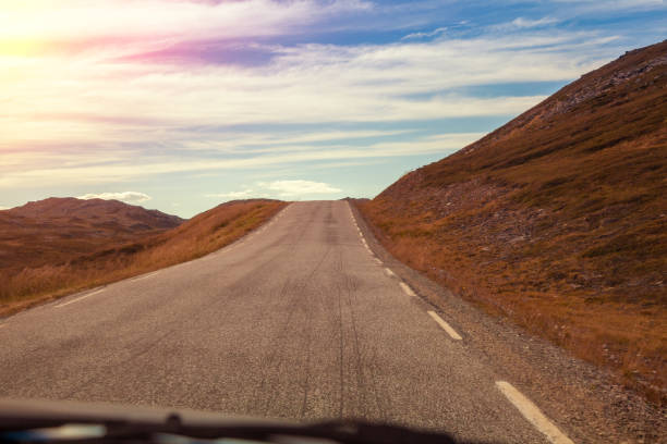 istock Driving a car on a mountain road. View from the windscreen. Beautiful harsh north minimalist landscape. Nature of Norway. Polar circle. The way to Nordkapp (North Cape). Norway 1279507070