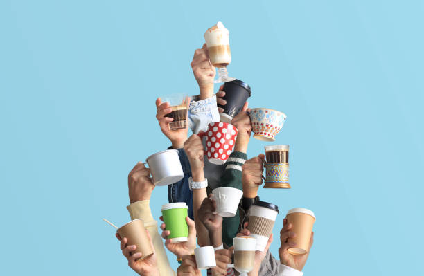 People are holding mugs and paper cups of coffee. People are holding mugs and paper cups of coffee. Concept on the theme of cafes and coffee. caffeine photos stock pictures, royalty-free photos & images
