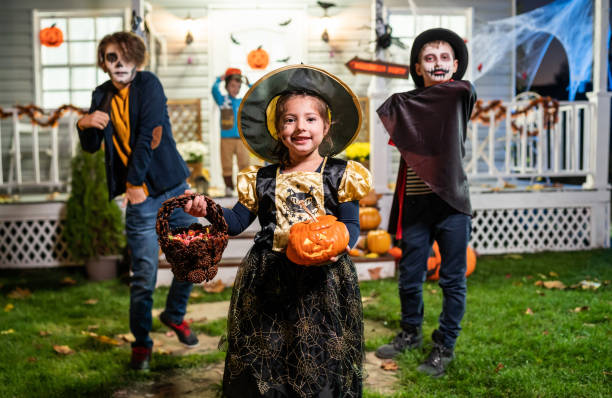 istock Young kids trick or treating at night during Halloween 1279510366