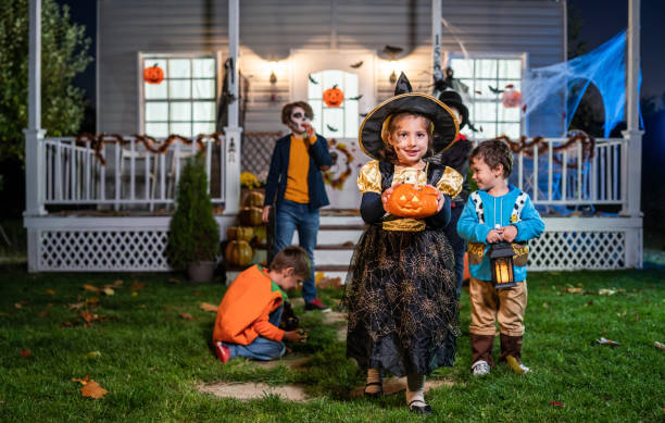 istock Young kids trick or treating at night during Halloween 1279510380