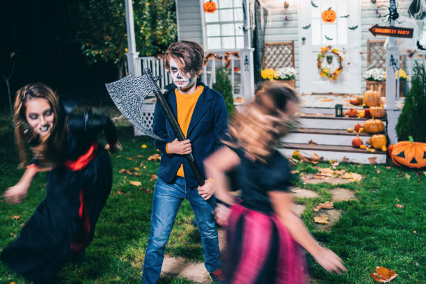 istock Young kids trick or treating at night during Halloween 1279510384