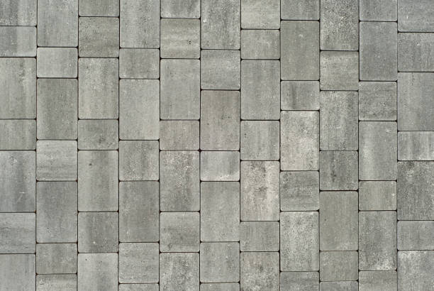 istock Cobblestone texture. The sidewalk tile is evenly folded. Gray cobblestones close up. 1279514306