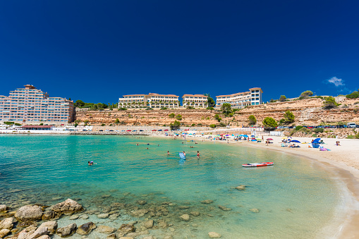 PORT ADRIANO, MALLORCA, SPAIN - 23 July 2020 - Tourists enjoying summer day on the popular city beach.