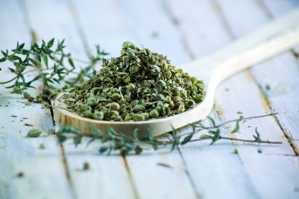 istock fresh Thyme and pile of dried thyme . 1279521578