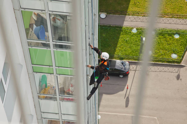istock Industrial mountaineering worker hangs over residential building while washing exterior facade glazing 1279522409