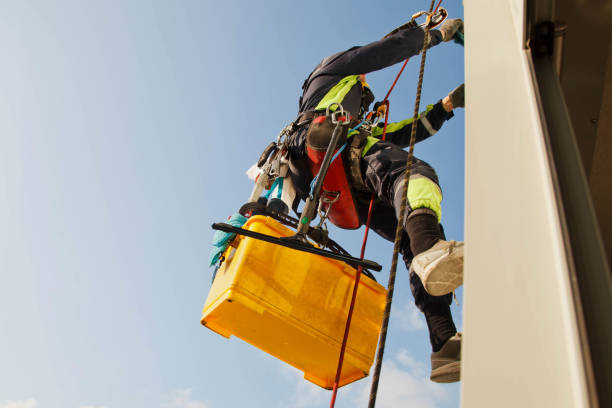 istock Industrial mountaineering worker hangs over residential building while washing exterior facade glazing 1279522416