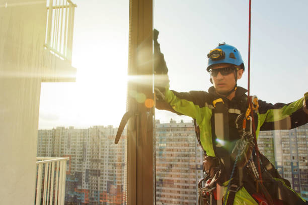 istock Industrial mountaineering worker hangs over residential building while washing exterior facade glazing 1279522450