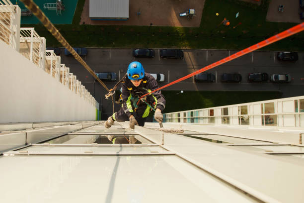 istock Industrial mountaineering worker hangs over residential building while washing exterior facade glazing 1279522453