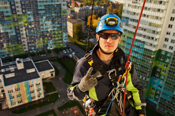 istock Industrial mountaineering worker hangs over residential building while washing exterior facade glazing 1279522494