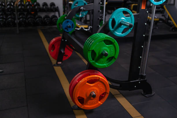 istock Lovely fit woman practicing squats in exercise machine in the gym 1279522577