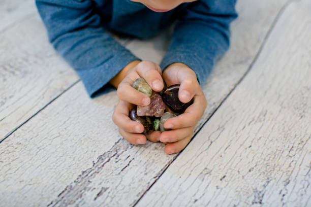 istock Child holding stones (crystals) in his hands 1279525123