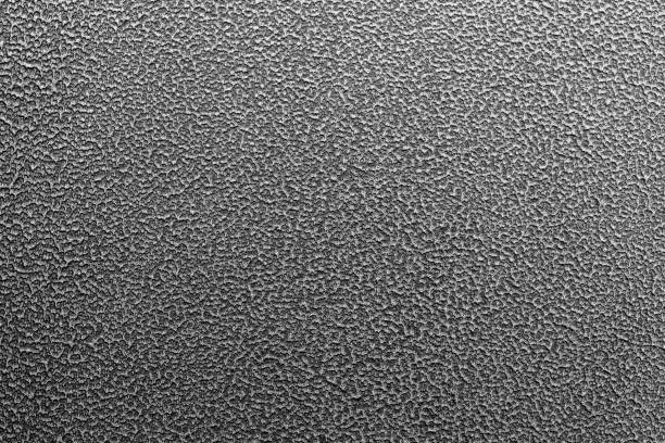 Texture and full frame background of hammered powder paint coating on flat sheet steel surface. Also known as hammertone effect.
