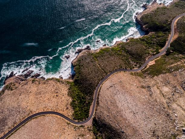 istock Aerial view over a winding coastal road 1279528982