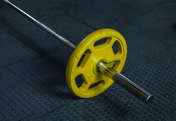 istock Heavy barbell in the gym. Free weight training 1279530251