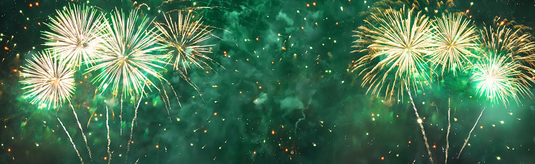 Wide Angle Holiday green background. Frame of fireworks. Panoramic beautiful template header for website With Copy Space for design for Christmas, New year, anniversary, independence day, Birthday