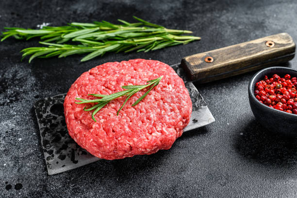 istock Burger Patty, ground beef meat.  Black background. Top view 1279531366