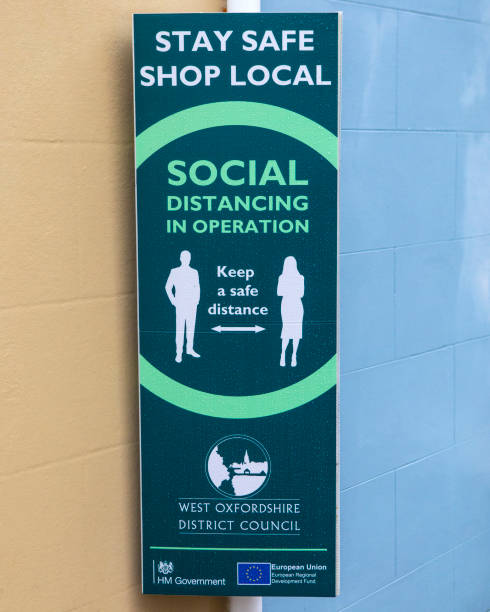 Social Distancing Sign in Woodstock, Oxfordshire, UK Oxfordshire, UK - October 3rd 2020: A social distancing information sign during the Coronavirus pandemic, in the town of Woodstock, Oxfordshire, UK. hm government stock pictures, royalty-free photos & images