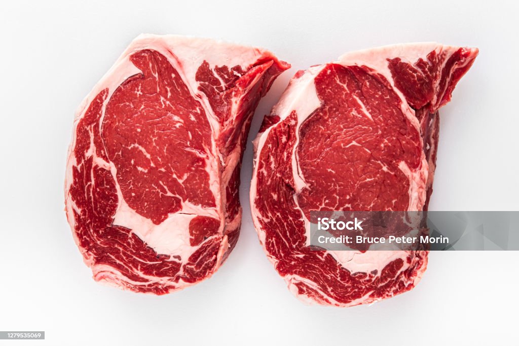 Boneless Rib Eye Steaks Two freshly cut boneless Rib Eye Steaks on a butchers table Rib Eye Steak Stock Photo