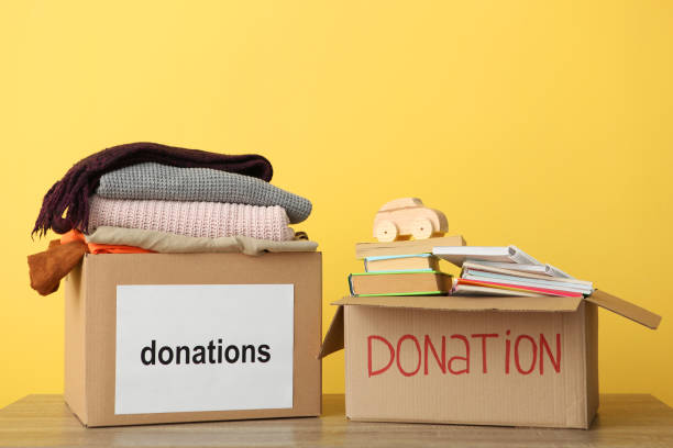 istock boxes with donations with the necessary things on the table. Charity, volunteering. 1279536191
