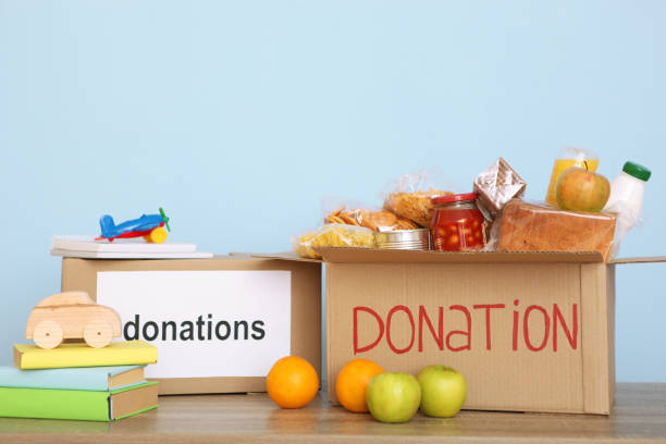 istock boxes with donations with the necessary things on the table. Charity, volunteering. 1279536194
