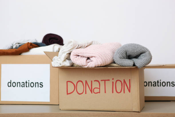 istock boxes with donations with the necessary things on the table. Charity, volunteering. 1279536242