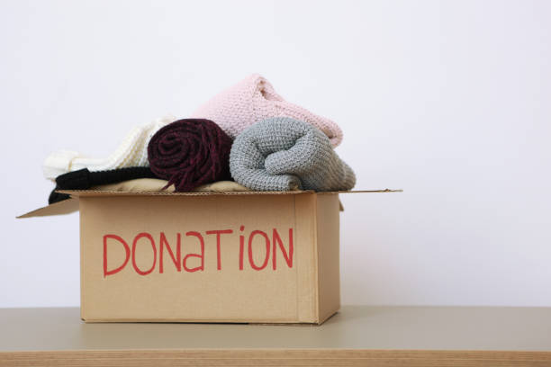 istock boxes with donations with the necessary things on the table. Charity, volunteering. 1279536298