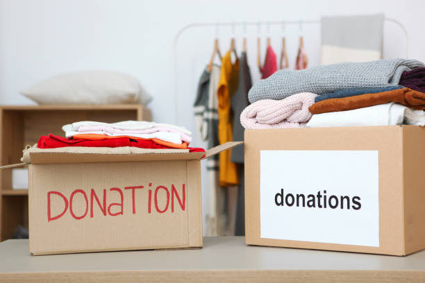 istock boxes with donations with the necessary things on the table. Charity, volunteering. 1279536320