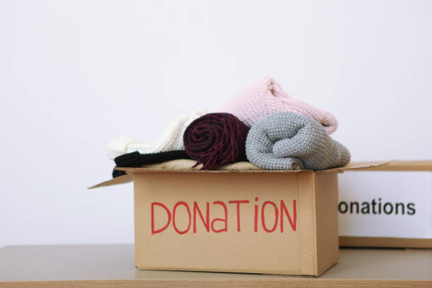 istock boxes with donations with the necessary things on the table. Charity, volunteering. 1279536392