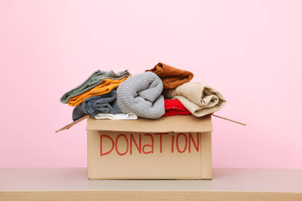 istock boxes with donations with the necessary things on the table. Charity, volunteering. 1279536395