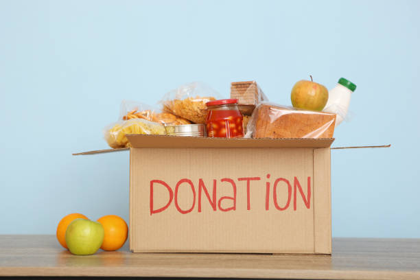 istock boxes with donations with the necessary things on the table. Charity, volunteering. 1279536396