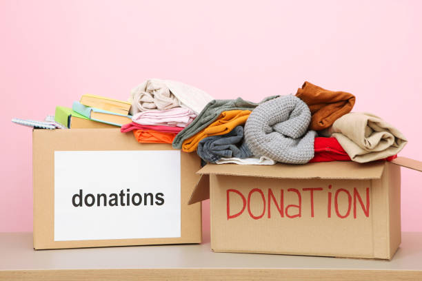 istock boxes with donations with the necessary things on the table. Charity, volunteering. 1279536999