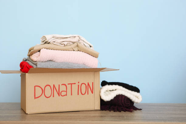 istock boxes with donations with the necessary things on the table. Charity, volunteering. 1279537001