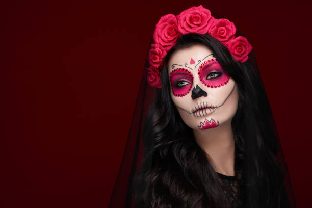 Portrait of a woman with makeup sugar skull Portrait of a woman with sugar skull makeup over red background. Halloween costume and make-up. Portrait of Calavera Catrina painted masquerade masks stock pictures, royalty-free photos & images
