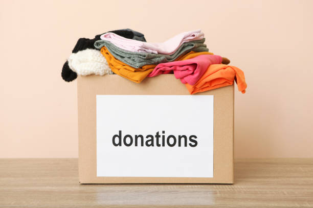 istock boxes with donations with the necessary things on the table. Charity, volunteering. 1279537163