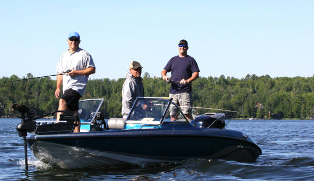 istock Three men in a blue boat, fishing 2. 1279541307