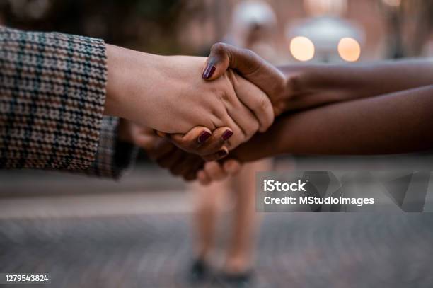Holding Hands Stock Photo - Download Image Now - Partnership - Teamwork, Real Life, Black People
