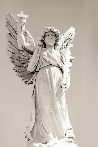 istock Black and white Angel, old statue of angle with cross, background with copy space 1279545954
