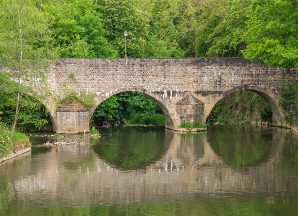istock An old stone bridge reflected in the water 1279547014