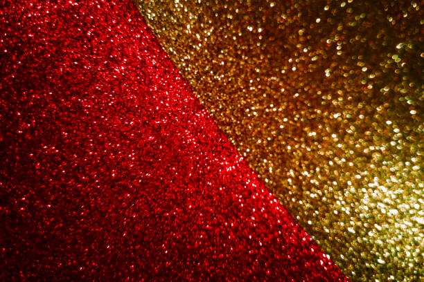 istock Abstract blurred background divided in half diagonally from gold and red shining, sparkling and shimmering glitter textures,dark and deep.Concept of festive Christmas or New Year background.Copy space 1279549544