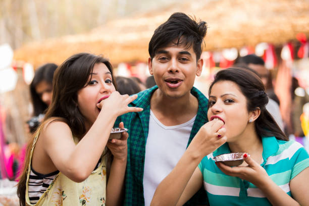 friends enjoying -  stock photo Indian, Indian ethnicity, modern, friends, adults, youth culture, panipuri stock pictures, royalty-free photos & images