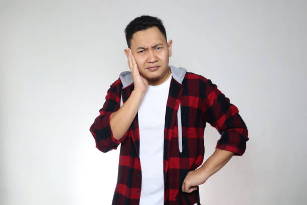 istock Young Asian looking starring at camera and thinking, confused expression. Close up body portrait over white 1279554919