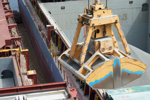 istock Loading and dischargind operation of bulk cargo bauxite on bulk carrier ship using grab bucket 1279555754