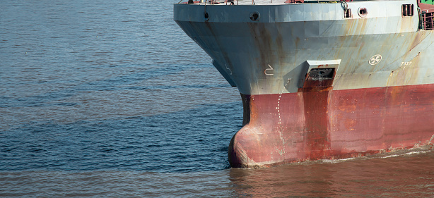 Closeup of multipurpose ship bulbous bow underway. Front view.