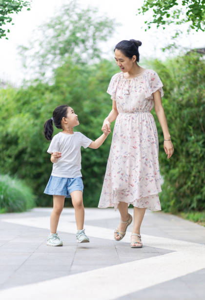istock Mom and daughter walking and talking 1279562609
