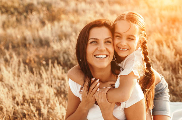 istock Happy daughter hugging mother in countryside 1279564450