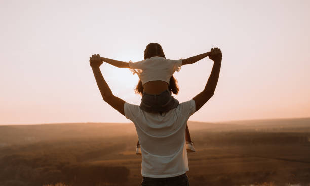 istock Anonymous father with daughter during sunset in nature 1279564456