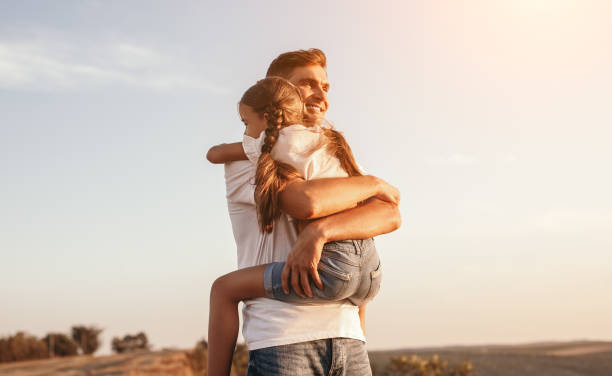 istock Happy father and daughter hugging in nature 1279564460