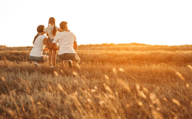 istock Anonymous family enjoying sunset in countryside 1279564461